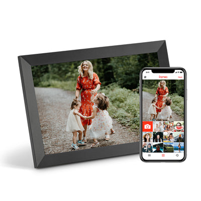 Digital photo frame displaying a family photo next to a smartphone showing the companion app with photo gallery grid.